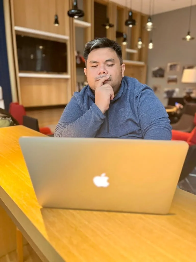 Christopher Jones Magalona working at a laptop in a co-working space.
